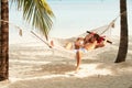 Romantic Couple Relaxing In Beach Hammock