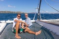 Romantic couple relaxing on a summer sailin cruise, sitting on a luxury catamaran, sailing in Maddalena Archipelago Royalty Free Stock Photo