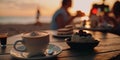 romantic couple relaxing,sunset beach cafe ,cup of coffee ,glass of wine,weet cake and flowers on table Royalty Free Stock Photo
