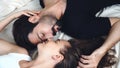 Romantic couple resting and lying down face to face together on the bed at home. Husband and wife sleeping holding hand on Royalty Free Stock Photo