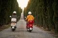 Romantic couple riding on a scooter in European on vacation. Back view