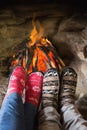 Romantic couple's legs in socks in front of fireplace Royalty Free Stock Photo