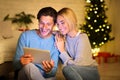 Romantic couple sharing digital tablet on winter evening Royalty Free Stock Photo