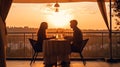 romantic couple sit in restaurant at sunset sea Royalty Free Stock Photo