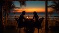 romantic couple sit in restaurant at sunset sea Royalty Free Stock Photo