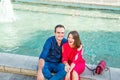 Romantic couple sitting on the bench near the city fountain and enjoying moments of happiness. Love, dating, romance. Lifestyle an Royalty Free Stock Photo