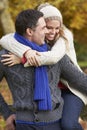 Romantic Couple Sitting On Fence In Autumn Woodland Royalty Free Stock Photo