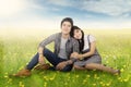 Romantic couple sitting at field in springtime Royalty Free Stock Photo