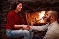 Romantic couple sitting on the floor in front of fireplace Royalty Free Stock Photo