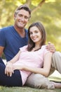 Romantic Couple Sitting On Grass In Summer Park Royalty Free Stock Photo