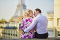 Romantic couple sitting on the roof near the Eiffel tower in Paris, France Royalty Free Stock Photo