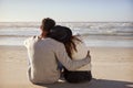 Romantic Couple Sitting On Winter Beach Together Royalty Free Stock Photo