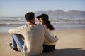 Romantic Couple Sitting On Winter Beach Together Royalty Free Stock Photo