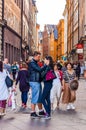 Romantic couple standing in the center of crowded medieval street in Gamla Stan, Old Town of Stockholm