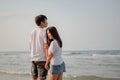 Romantic couple standing holding hands each other while at beach at sunrise, plan life at future concept.