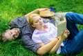 Romantic couple students enjoy leisure with poetry or literature grass background. Couple soulmates at romantic date Royalty Free Stock Photo