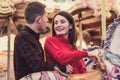 Romantic couple taking a moment to kiss while riding horses on carousel Royalty Free Stock Photo