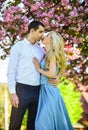 Romantic couple under sakura tree. couple in love kiss and embrace. spring flower bloom. man and woman in park with pink Royalty Free Stock Photo