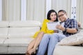 Romantic couple using a digital tablet at home