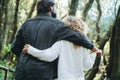 Romantic couple viewed from back hugging and bonding with love and romance. Happy relationship lifestyle. Man and woman enjoying Royalty Free Stock Photo