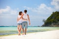 Romantic couple walking along tropical beach Royalty Free Stock Photo