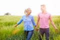 Romantic Couple Walking In Field Holding Hands Royalty Free Stock Photo