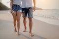 Romantic couple walking holding hands each other while at beach at sunrise, plan life insurance at future concept.