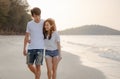 Romantic couple walking hugging each other while at beach at sunrise, plan life insurance at future concept.