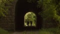 Romantic Couple Walking Through a Tunnel