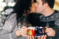 Couple kissing with christmas hot chocolate marshmallow cups Royalty Free Stock Photo