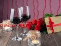 Romantic cozy evening with wine, flowers, candles and present Royalty Free Stock Photo