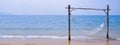 Romantic cozy hammock on the tropical beach by the sea. Peaceful seascape. Relax, travel concept, travelling.