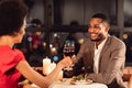 Spouses Clinking Red Wine Glasses Celebrating Anniversary In Fancy Restaurant Royalty Free Stock Photo