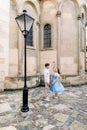 Romantic date and dance outdoor in the city. Happy young couple, man in white shirt and charming girl in blue dress Royalty Free Stock Photo