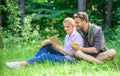 Romantic date at green meadow. Couple in love spend leisure reading book. Romantic couple students enjoy leisure with Royalty Free Stock Photo