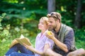 Romantic date at green meadow. Couple in love spend leisure reading book. Couple soulmates at romantic date. Pleasant