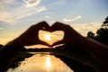 Romantic date ideas. Idea honeymoon travel. Sunset sunlight romantic atmosphere. Hands heart gesture symbol of love and