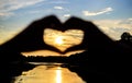 Romantic date ideas. Idea honeymoon travel. Vacation resort. Sunset sunlight romantic atmosphere. Hands in heart shape