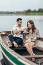 Romantic date. Man feeding his girlfriend cake Royalty Free Stock Photo