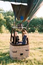 Romantic date, marriage proposal, engagement, wedding anniversary concept. Couple in love sitting in the basket of hot Royalty Free Stock Photo