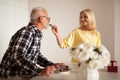 Romantic date of a mature couple of people. Senior husband and wife celebrate their wedding anniversary at the table. The mistress