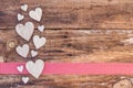 Hearts decoration on red ribbon border and wooden background Royalty Free Stock Photo