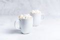 Romantic desk top with two cups of coffee with marshmallows on marble table. Close-up. Royalty Free Stock Photo