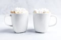 Romantic desk top with two cups of coffee with marshmallows on marble table. Close-up. Royalty Free Stock Photo