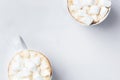 Romantic desk top with two cups of coffee with marshmallows on marble table. Top view.