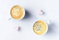 Romantic desk top with two cups of coffee and pink heart shaped marshmallows. Top view. Royalty Free Stock Photo