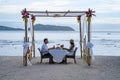 Romantic dinner on the beach, couple man and woman mid age having a romantic dinner on the beach in Phuket Thailand Royalty Free Stock Photo