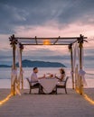 Romantic dinner on the beach, couple man and woman mid age having a romantic dinner on the beach in Phuket Thailand Royalty Free Stock Photo