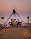 Romantic dinner on the beach, honemoon dinner on the beach during sunset Thailand, valentine setting Royalty Free Stock Photo