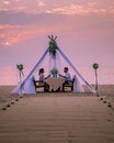 Romantic dinner on the beach, honemoon dinner on the beach during sunset Thailand, valentine setting Royalty Free Stock Photo